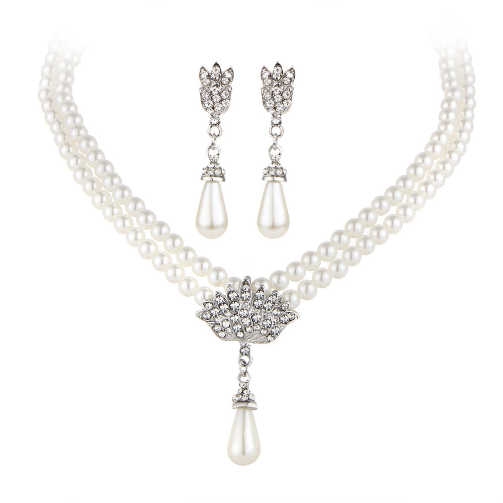 Pearl necklace with a pendant and matching earrings on a white background